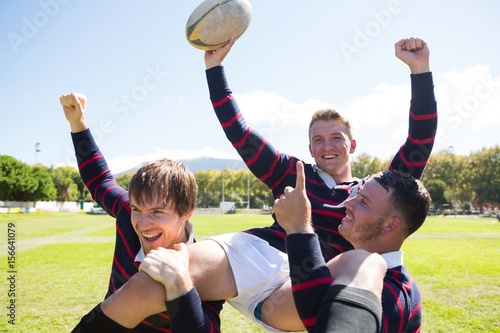 Portrait of happy rugby players enjoying at field  photo