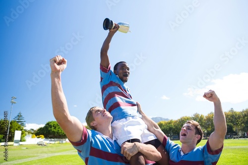 Happy rugby team enjoying victory 