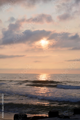 Fototapeta Naklejka Na Ścianę i Meble -  Heavenly Summer Seashore Sunrise Over Rock Jetty on the Beach