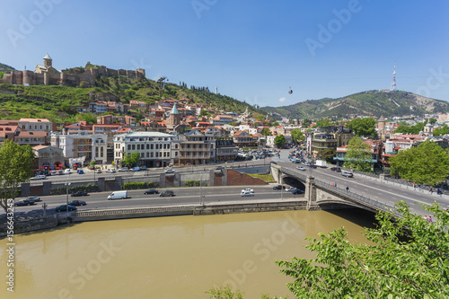 Panorama view of Tbilisi, capital of Georgia country. Landmarks - Narikala fortress, cable road above tiled roofs, Meidan square. photo