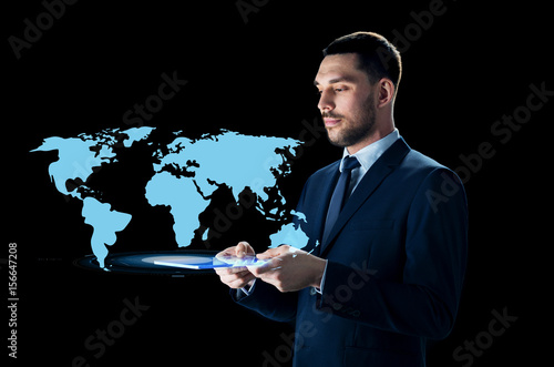 businessman with tablet pc and world map