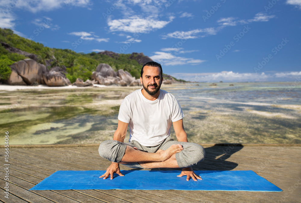 man making yoga in scale pose outdoors