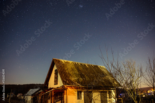 wooden house on a background of the night sky