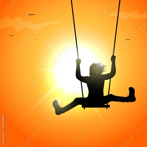 Baby silhouette on swing at sunset