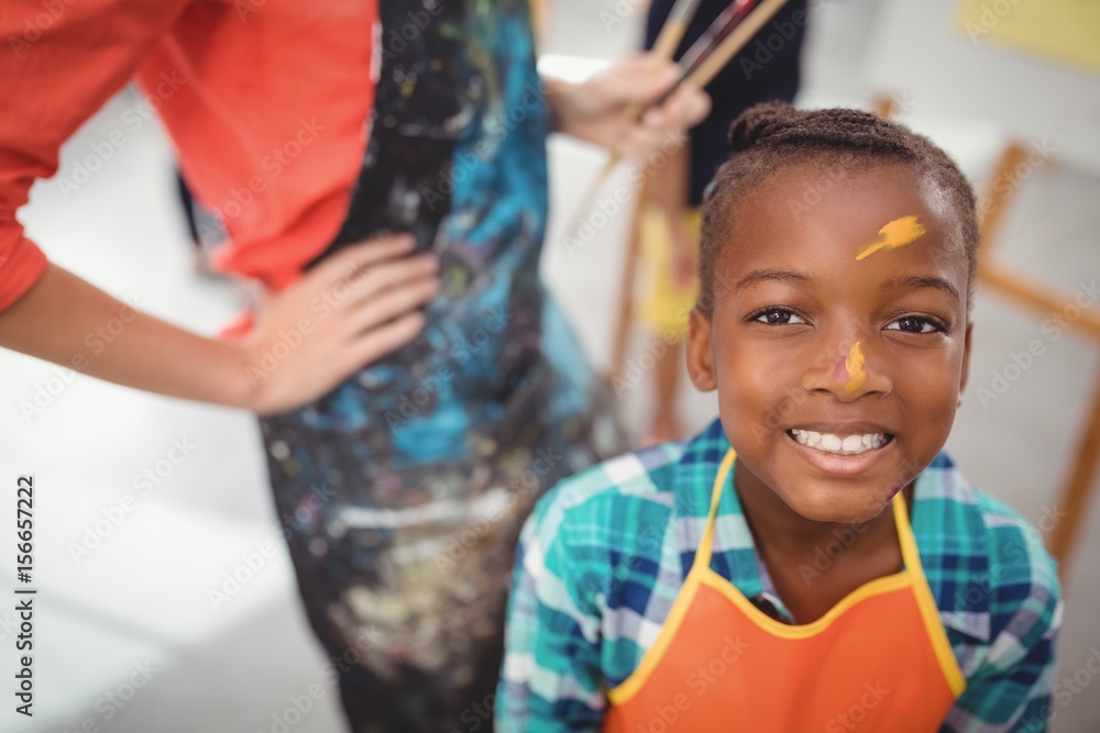 Obraz premium smiling girl with paint on face