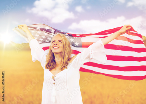 happy woman with american flag on cereal field photo