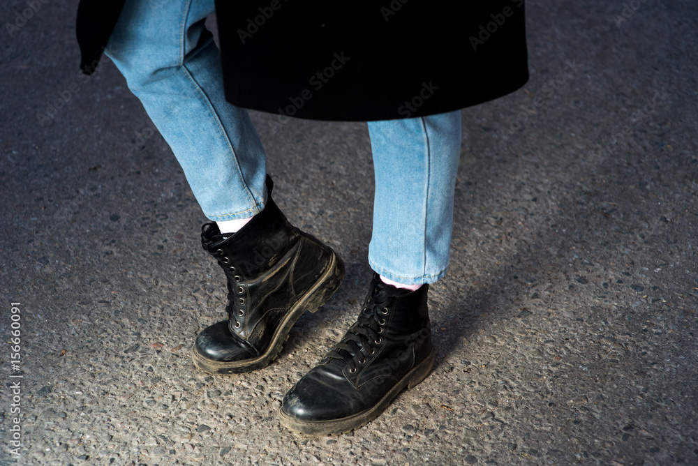 Stylish young fashionable girl with high heel winter boots and black leather bag. Winter street fashion look. Harajuku fashion Stylish young fashionable girl with high heel winter boots and black leather bag. Winter street fashion look. Harajuku fashion