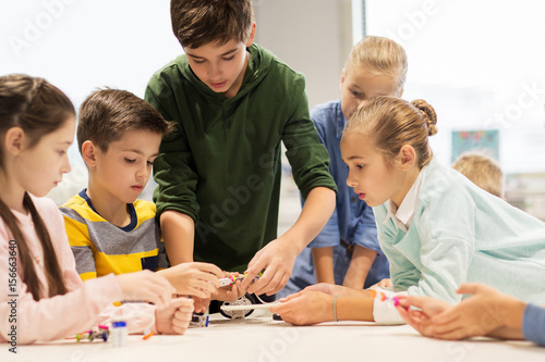happy children building robots at robotics school