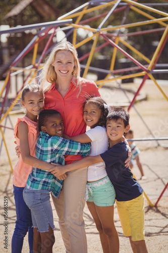 Happy trainer and schoolkids standing together 