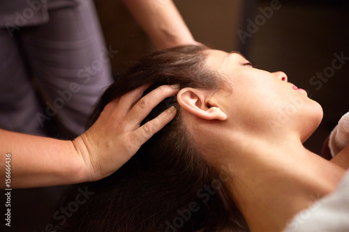 woman having head massage at spa