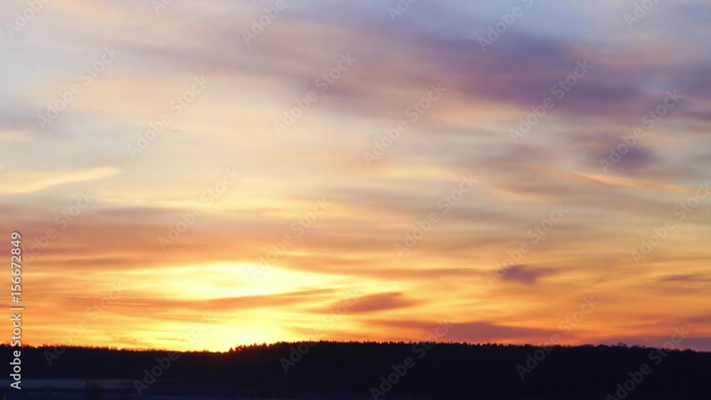 Beautiful floating clouds in the pink morning haze of dawn and the rising sun Beautiful floating clouds in the pink morning haze of dawn and the rising sun