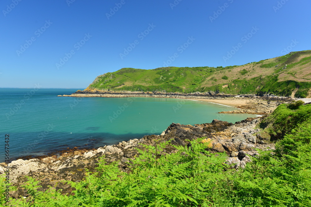 Giffard Bay, Jersey, U.K.  Wide angle image of a picturesque beach with a teal sea.