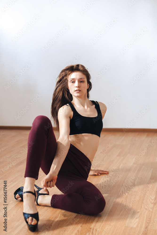 Young dancer in movement in the classroom on the floor Young dancer in movement in the classroom on the floor