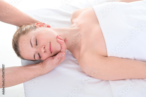 Close-up of beautiful young woman receiving massage at health spa