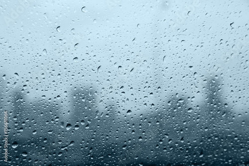 water droplets on mirror with blurred city background