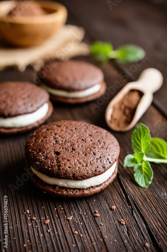Traditional chocolate Whoopie pies filled with cream photo