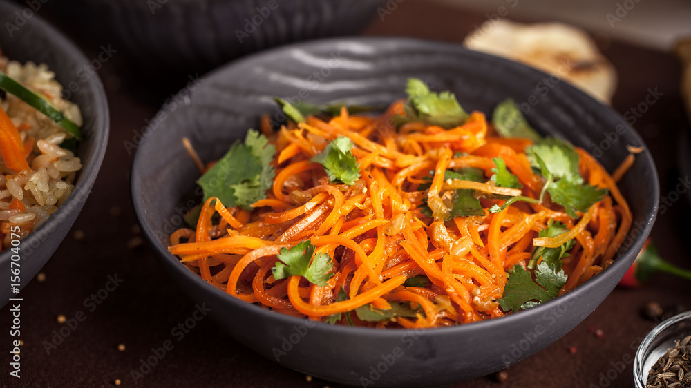 Asian korean carrot salad with spices in the ?lay plate Asian korean carrot salad with spices in the ?lay plate