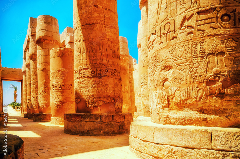 Naklejka premium Travel in Egypt. Great Hypostyle Hall and clouds at the Temples of Karnak (ancient Thebes). Luxor, Egypt