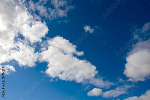 Panorama of the cloudy sky  background with large white clouds in the atmosphere.