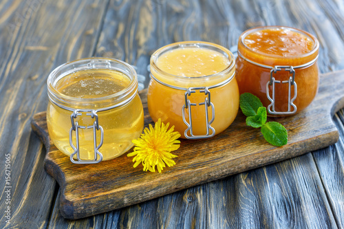 Different varieties of honey in a glass jars. photo