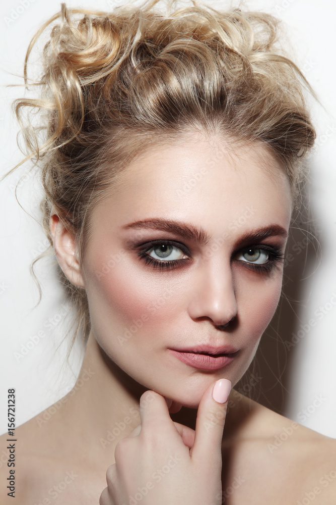 Young beautiful woman with smoky eyes and prom hairdo Young beautiful woman with smoky eyes and prom hairdo