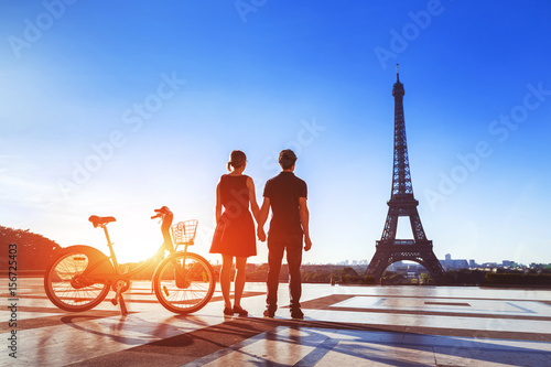 Couple with bicycle looking at Eiffel Tower on Trocadero © NicoElNino