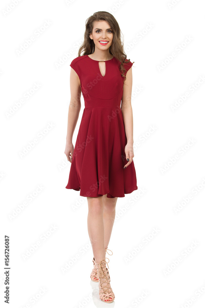 Young Woman In Elegant Burgundy Dress Is Walking Young Woman In Elegant Burgundy Dress Is Walking