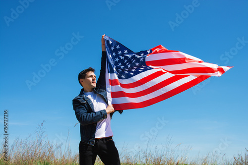 man is holding waving american USA flag. memorial day card 