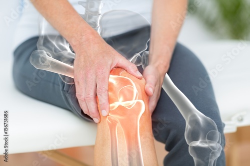 Mid section of man suffering with knee pain  photo