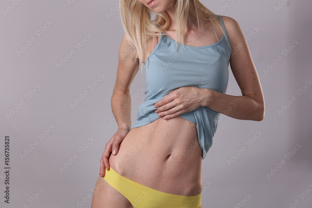 Naklejka premium Healthy attractive woman body, waistline. Slim female torso, abdomen close up. Sport, fitness, Dieting results,laser lipolysis, active lifestyle concept