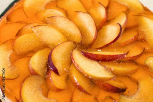 Wallpaper Mural Fruit cake with peach, jelly and mousse in plate on wooden background. Torontodigital.ca