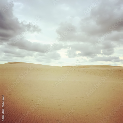 Sand dunes and cloudy sky