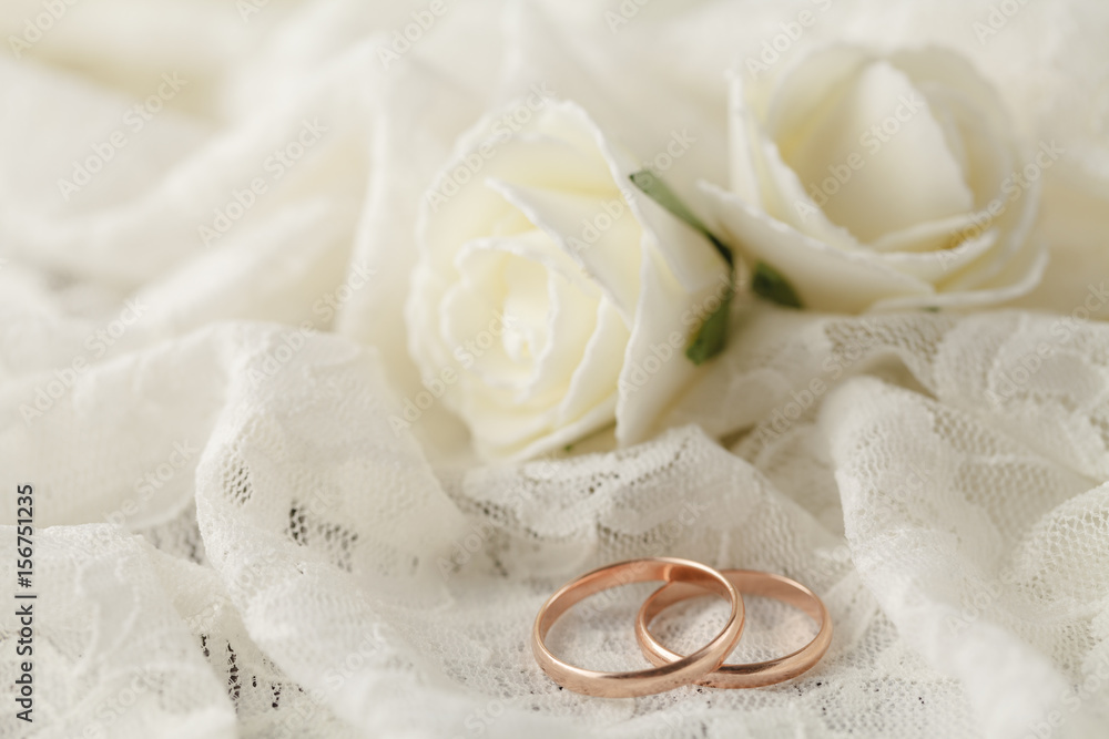 The rings on the flowers on a white fabric, wedding details The rings on the flowers on a white fabric, wedding details