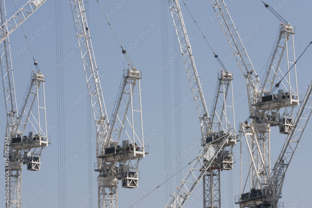 Cranes in construction site for new apartments Cranes in construction site for new apartments