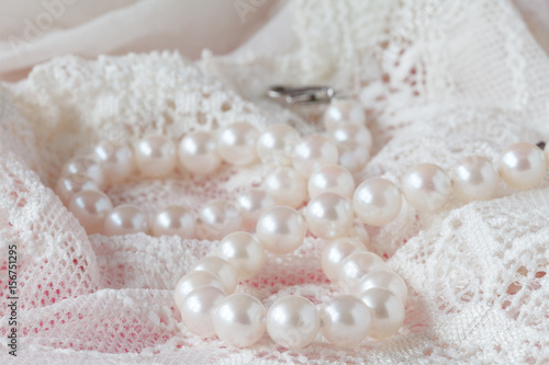 White pearls necklace on toilette table. Selective focus.