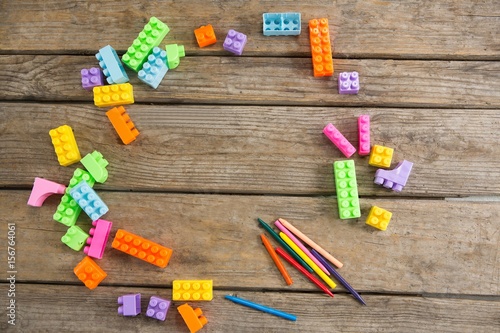Overhead view of toy blocks with crayons on table