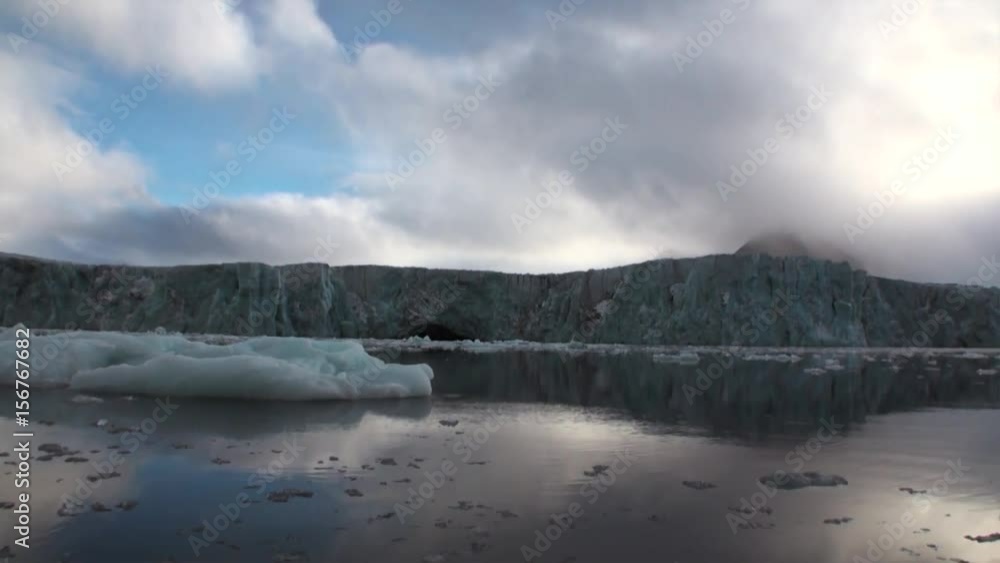 Glacier on the coast in the background of water of Arctic Ocean in Svalbard. Wildlife in Nordic badlands. Unique footage on background natural landscape and snow of Spitsbergen. Glacier on the coast in the background of water of Arctic Ocean in Svalbard. Wildlife in Nordic badlands. Unique footage on background natural landscape and snow of Spitsbergen.