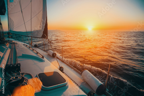 Sailing boat in the sea during awesome sunset. Luxury yacht and cruise holiday..