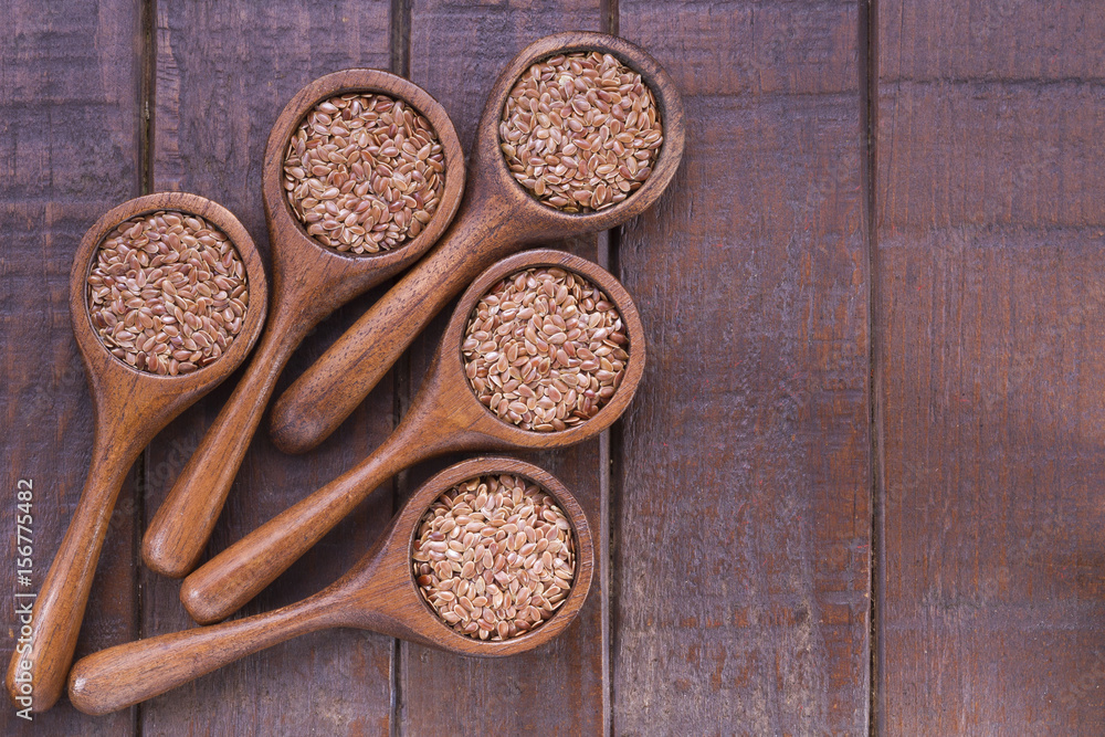 Flax seeds in wooden bowl and spoon Flax seeds in wooden bowl and spoon