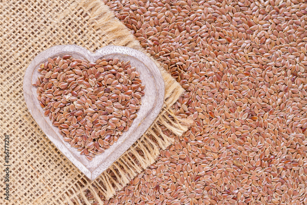 Flax seeds in wooden bowl and spoon Flax seeds in wooden bowl and spoon