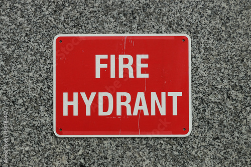 red and white Fire Hydrant sign on granite wall background
