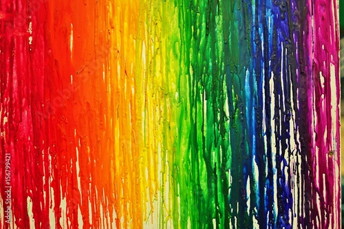 Fotografie LGBTQ pride rainbow flag painted with colorful bleeding paint  streaks on a wall
