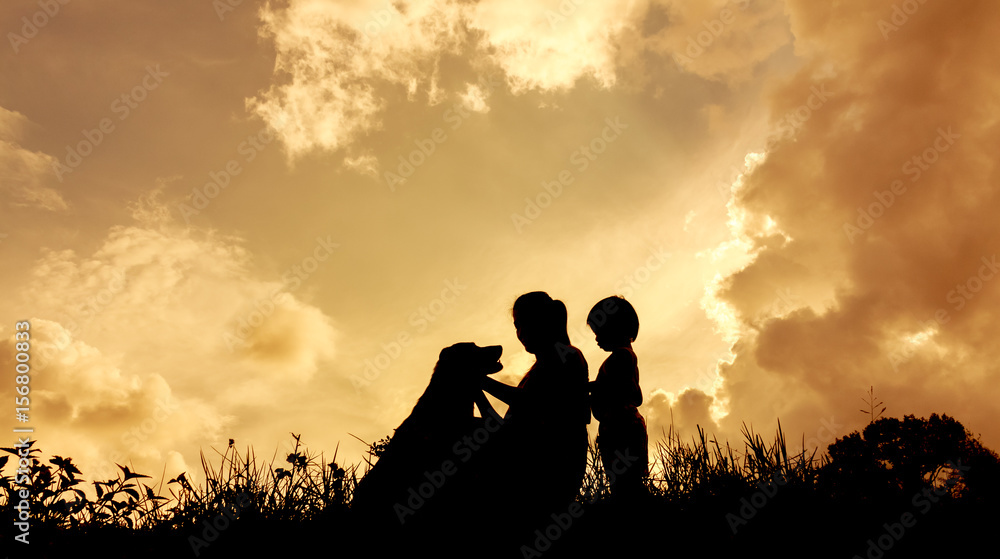 silhouettes of a women with her kid and dog during sunset