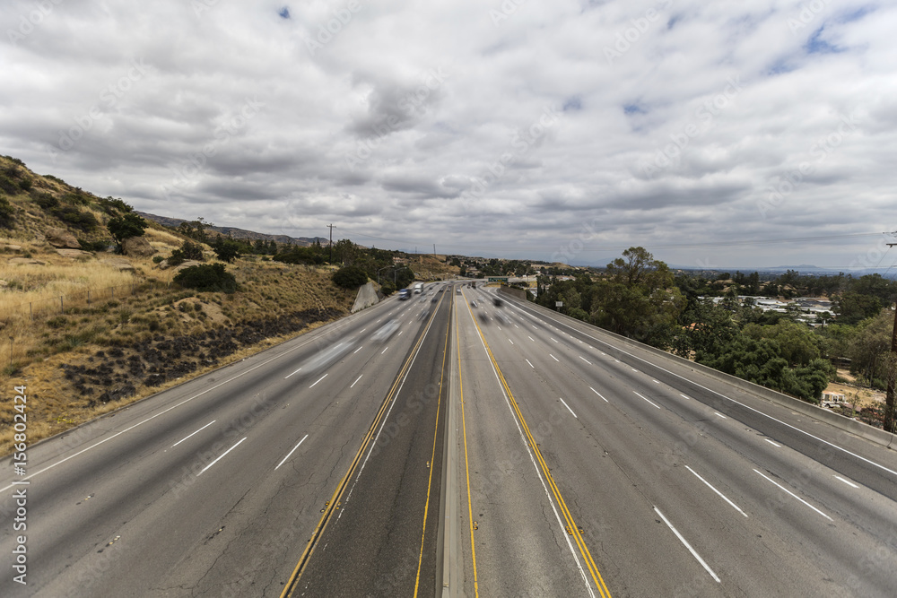 Ten lane 118 freeway with motion blurred traffic in the San Fernando Valley area of Los Angeles, California.  