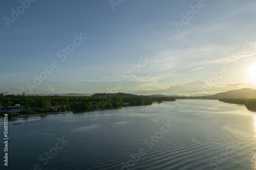 Beautiful sunrise over Mount Kinabalu and river Ganyang in Sabah, Malaysia. View point from Mengkabong bridge