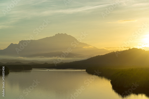 Beautiful sunrise over Mount Kinabalu and river Ganyang in Sabah  Malaysia. View point from Mengkabong bridge