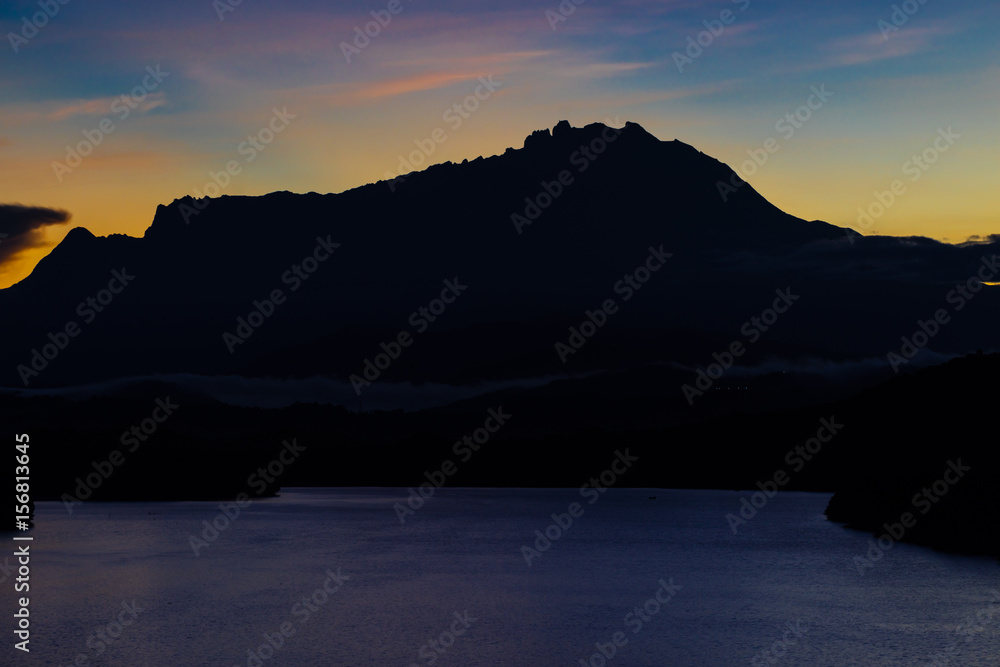 Beautiful sunrise over Mount Kinabalu and river Ganyang in Sabah, Malaysia. View point from Mengkabong bridge