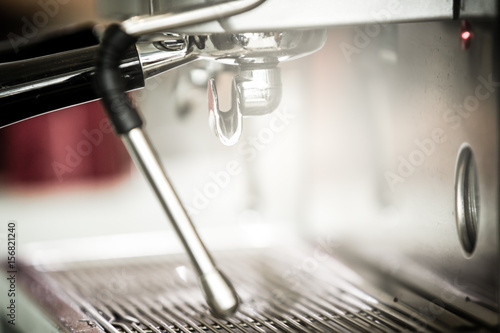 Modern espresso machine in small coffee bar close up. (Processed in vintage colour tone)