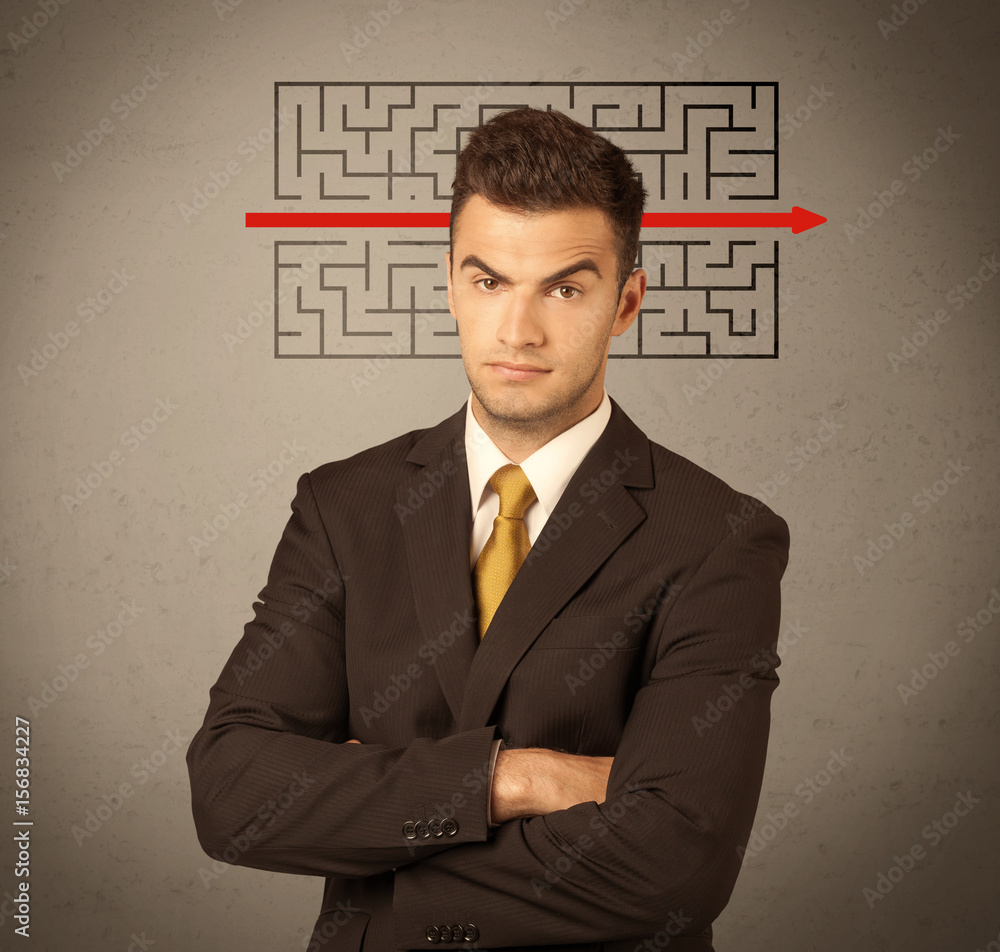 Handsome business guy solving maze Handsome business guy solving maze