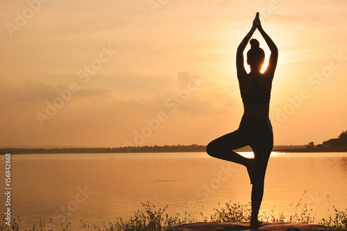 Silhouette women yoga in nature ,color of vintage tone